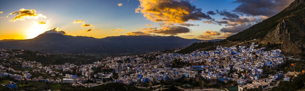 Panorama of a winter sunset over the mountains and The Blue City of Chefchaouen, Morocco