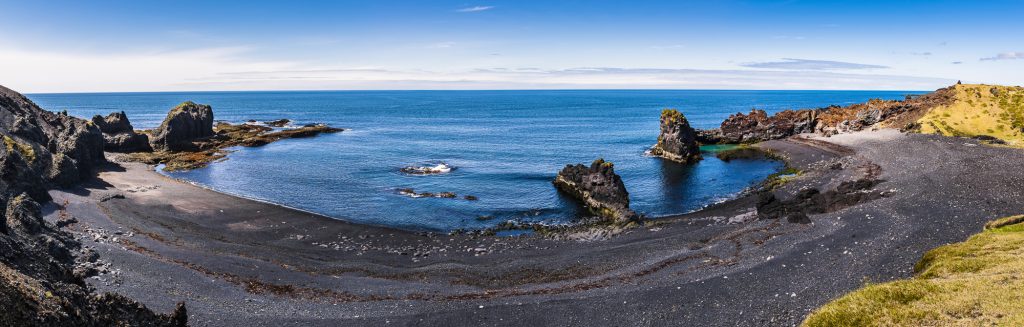 Panorama of the volcanic beach, sea and green pool at Dritvik Cove on the Snaefellsnes Peninsula, Iceland