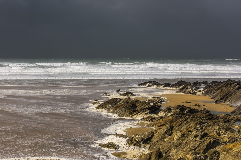 Dark clouds and stormy waves over Fistral Beach, near Newquay, Cornwall