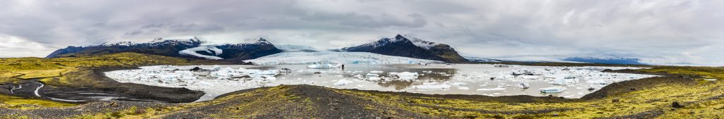 Panorama of the icebergs and lake at Fjallsarlon Lagoon in front of the Fjallsjokull glacier, Iceland