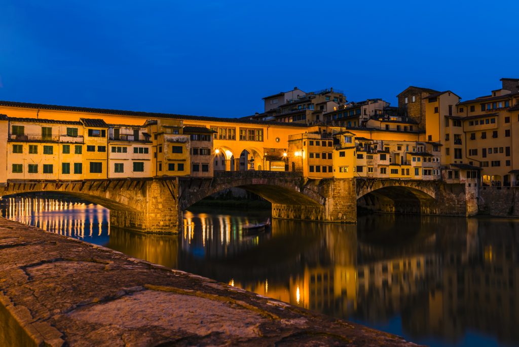 Long exposure at dusk of the Ponte Vecchio bridge over the Arno River, Florence, Tuscany, Italy