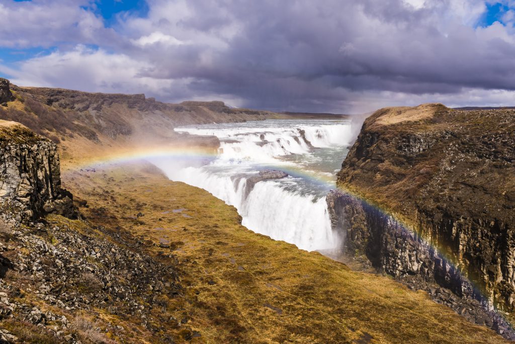 Rainbow over the huge river and waterfall at Gullfoss, Iceland