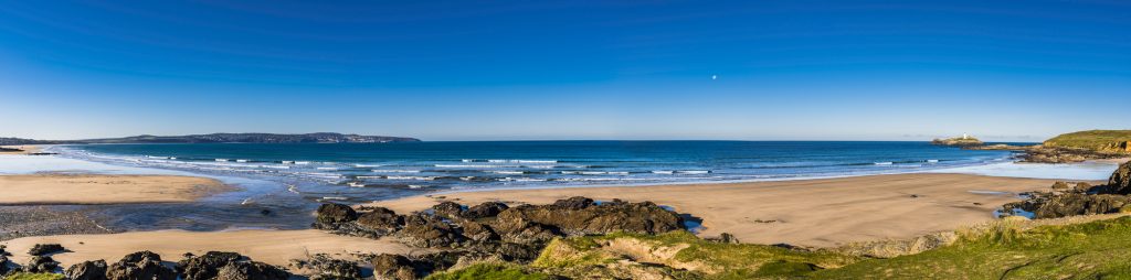 Early morning autumn panorama over Gwithian Beach and Godfrey Lighthouse, near Hayle, Cornwall