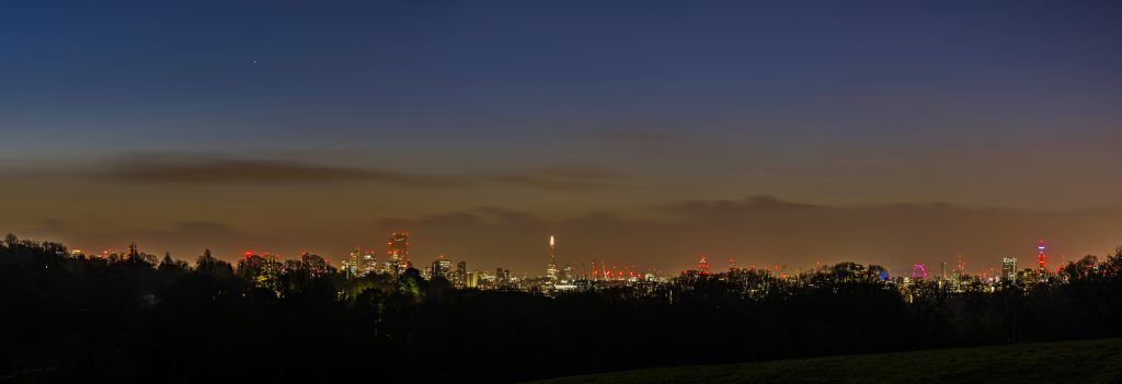 Panorama of a winter dawn over the London skyline from Canary Wharf, via the The Shard to the BT Tower, taken from Hampstead Heath, London
