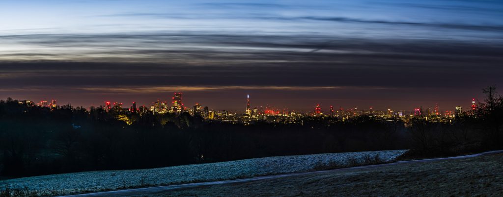 Panorama of a winter dawn over the London skyline from Canary Wharf, via the The Shard to the BT Tower, taken from Hampstead Heath, London
