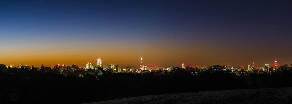 Panorama of a winter dawn and sunrise over the London skyline from Canary Wharf, via the The Shard to the BT Tower, taken from Hampstead Heath, London