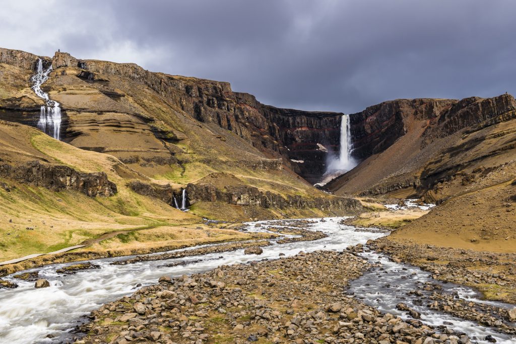 Tall waterfall at Hengifoss on a stormy day, Iceland