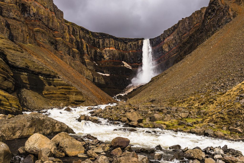 Tall waterfall and river at Hengifoss on a stormy day, Iceland