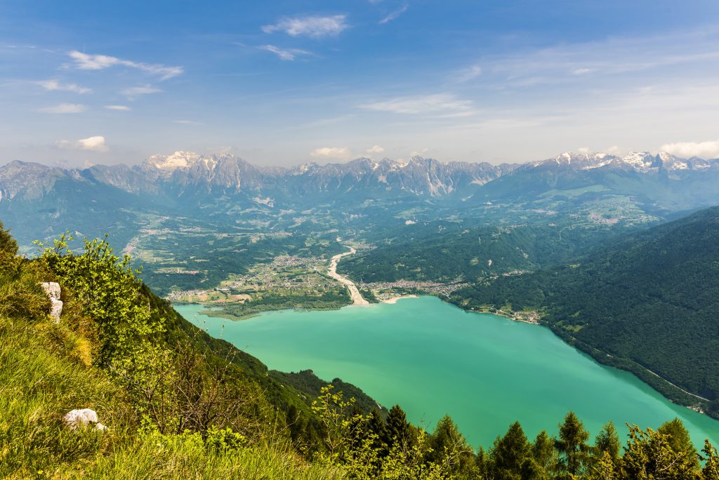 Looking down from Nevegal on the lake at Lago di Santa Croce in the Dolomite mountains, near Puos d'Alpago, Veneto, Italy