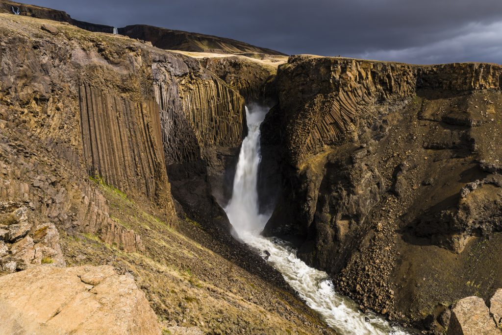 Narrow waterfall through the basalt at Litlanesfoss, near Hengifoss, Iceland