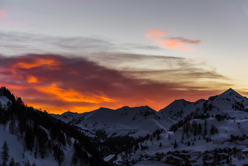 Sunset and red skies over the snowy Alps and mountains at Obertauern, Austria