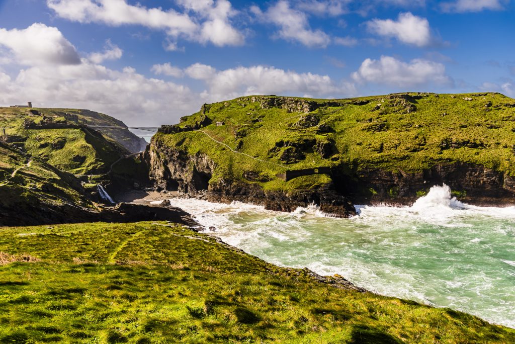 Stormy spring waves and surf crashing on to the beach at Tintagel Haven, Tintagel, Cornwall