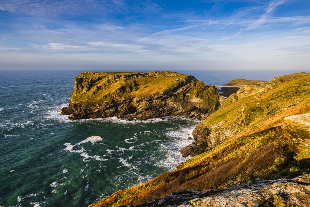 Late afternoon winter sunlight over Tintagel Island and castle, Tintagel, Cornwall