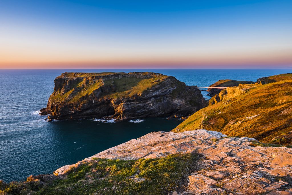 Spring sunset light over Tintagel Island and castle, Tintagel, Cornwall