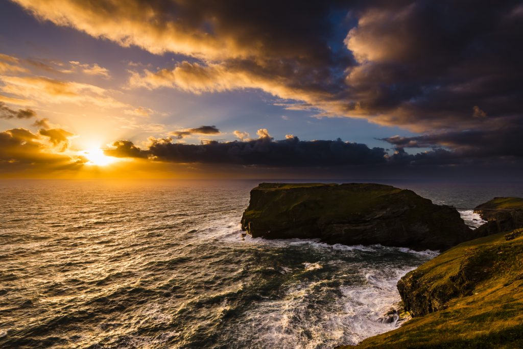 Summer solstice sunset over Tintagel Island and castle, Tintagel, Cornwall