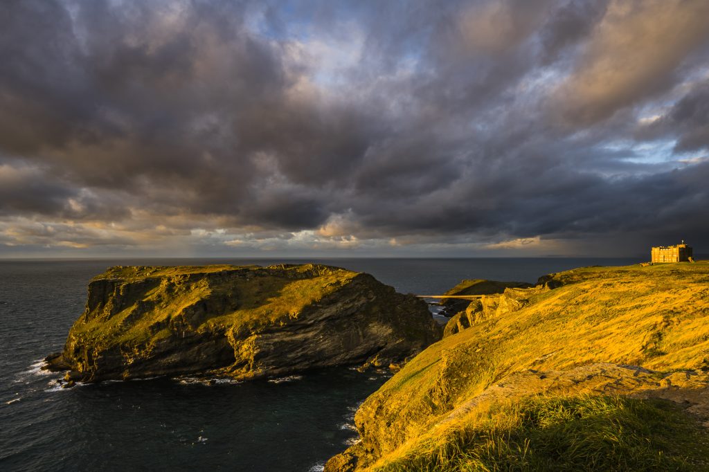Autumn sunset light over Tintagel Island and castle, Tintagel, Cornwall