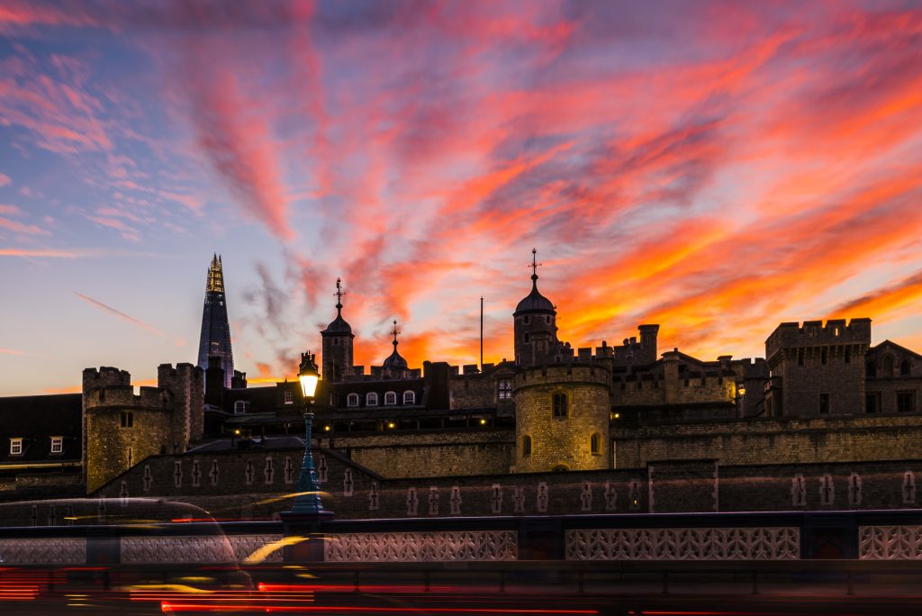 Red skies and light trails at sunset in autumn at the Tower of London, London