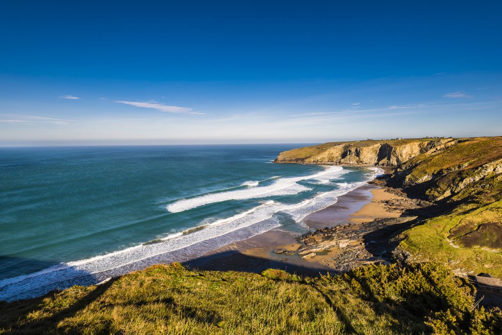 Early morning winter sunlight over Trebarwith Strand beach, near Tintagel, Cornwall
