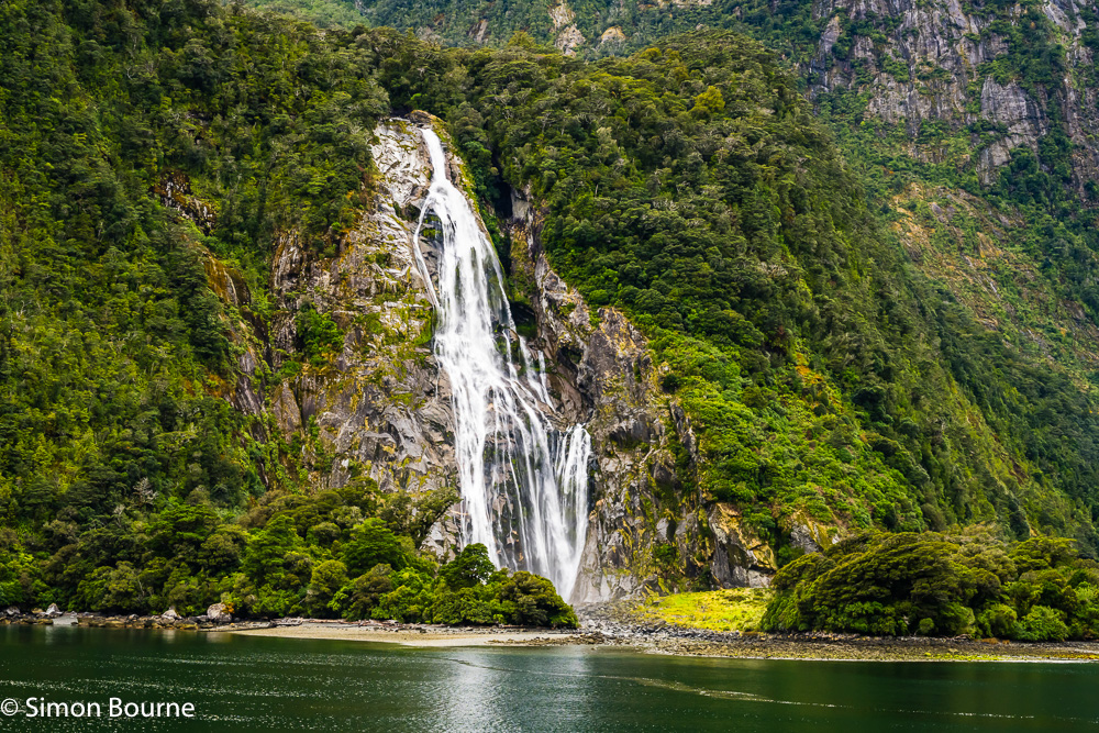 Autumn landscape view of the Lady Bowen Falls and mountains at Milford Sound in Fiordland National Park, Southland, South Island, New Zealand