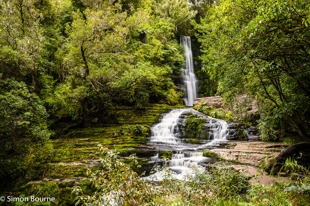 Long exposure on an autumn day at McLean Falls waterfall on the Tautuku River in The Catlins, Otago, South Island, New Zealand