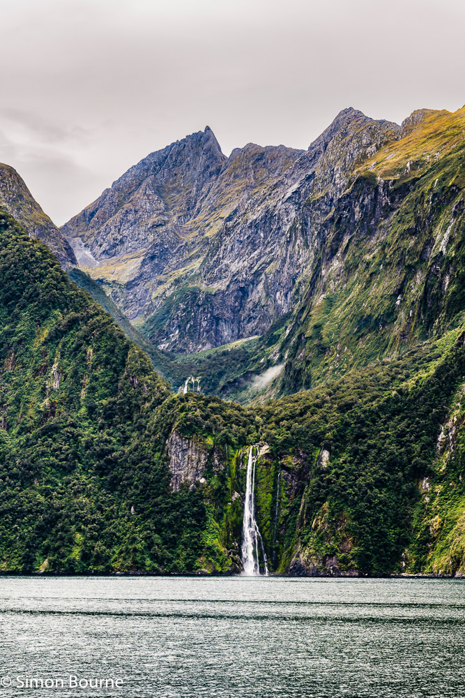 Autumn landscape view of the Stirling Falls, hanging valley and mountains at Milford Sound in Fiordland National Park, Southland, South Island, New Zealand