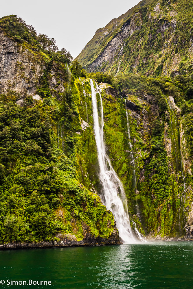 Autumn landscape view of the Stirling Falls, hanging valley and mountains at Milford Sound in Fiordland National Park, Southland, South Island, New Zealand