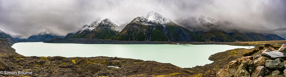 Autumnal snowy landscape panorama over the Tasman Lake and Glacier, and surrounding mountains in the Mount Cook National Park, Canterbury, South Island, New Zealand